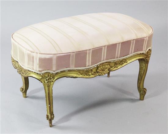 A Louis XV style carved giltwood oval foot stool, W.2ft 8in.